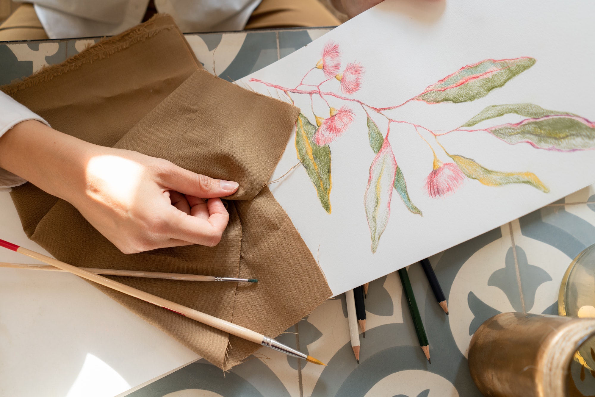 woman-at-table-near-draw-on-paper-and-material.jpg